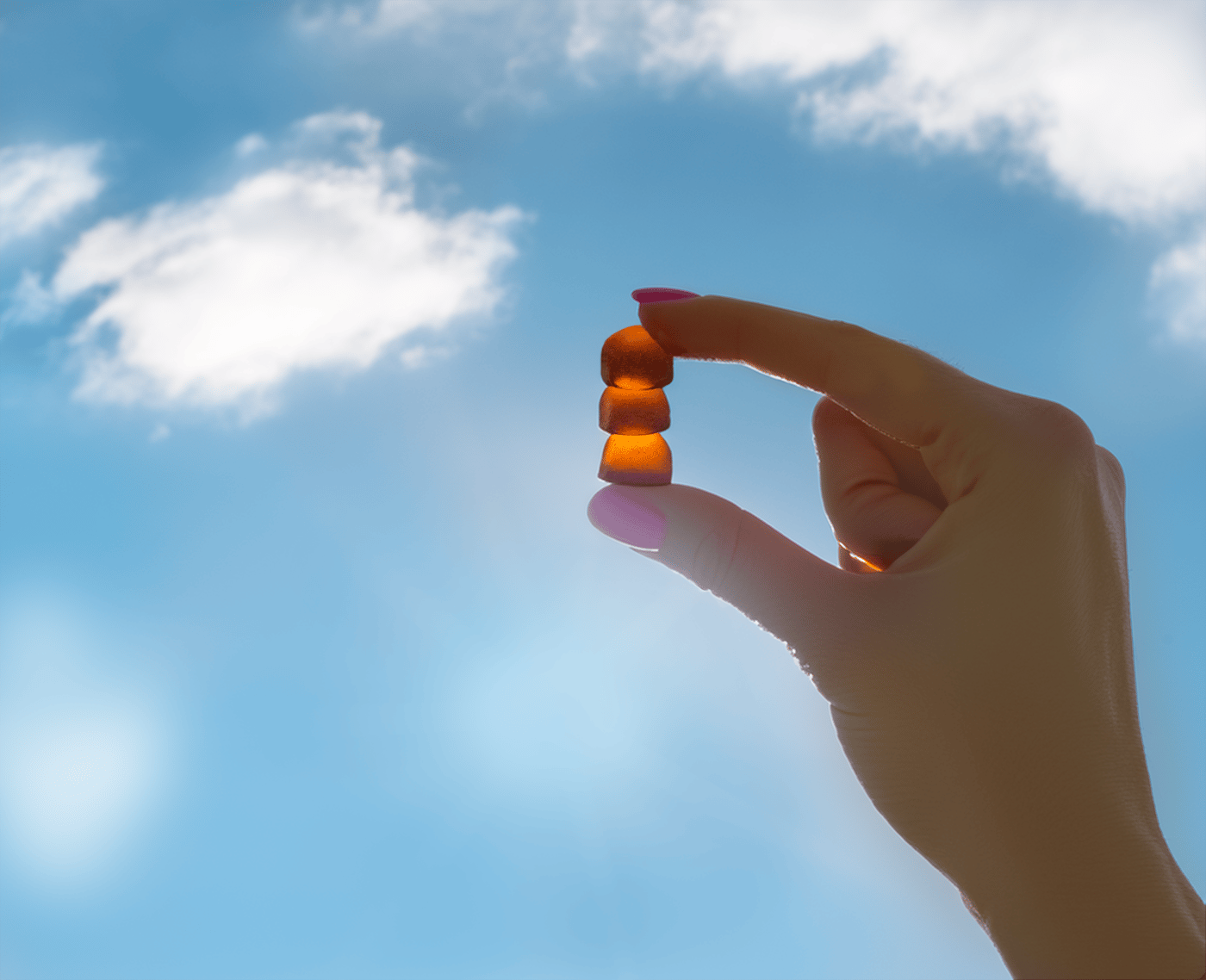 Hand holding vitamin d3 + zinc gumies